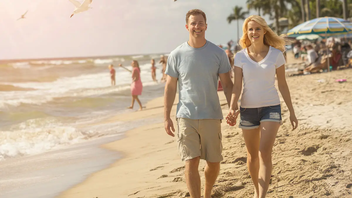 a couple walking hand to hand at tampa beach